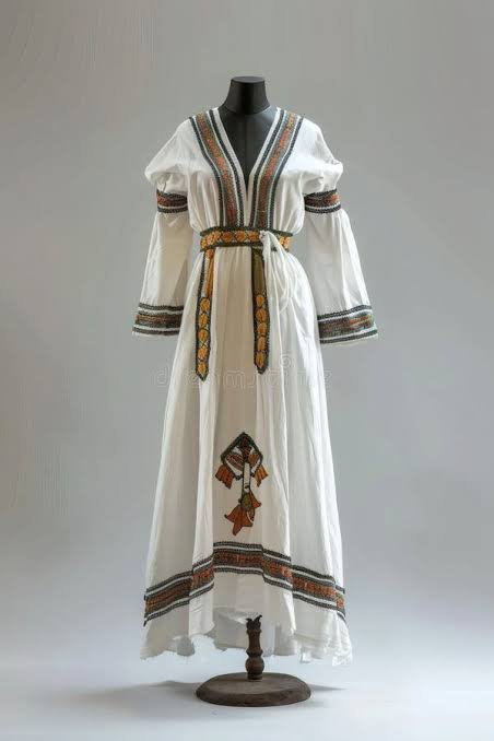 Traditional hand-woven Habesha Kemis dress in white cotton with coloured Tilf embroidery borders.